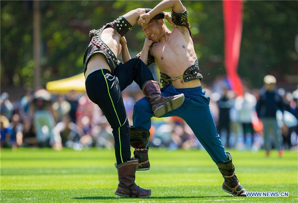 1527210897744097093.jpg Two wrestlers of Hohhot Minzu College compete at a Nadam fair of the school in Hohhot.jpg