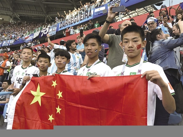 1530609643863063036.jpg Young football fans hold the Chinese flag at a World Cup match..jpg