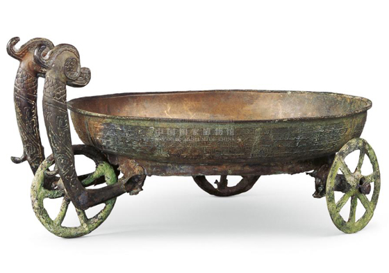 Bronze tricycle-like plate decorated with twin beasts from over 2,000 years ago