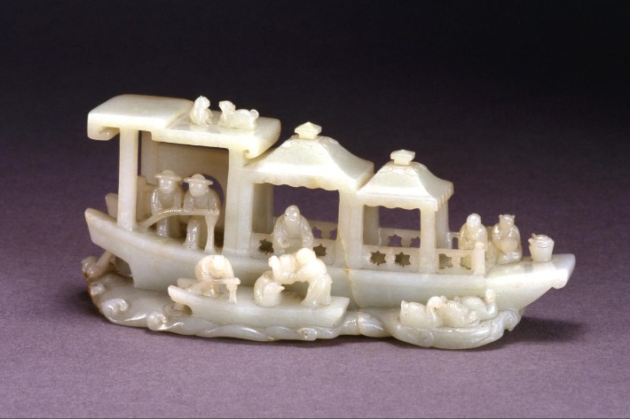 White jade carving captures a miniature world on water