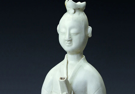 White-glazed Ding ware ewer in the shape of a reading child