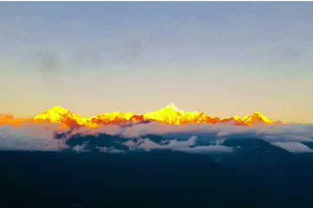 Snow mountain shines with golden glow in Yunnan