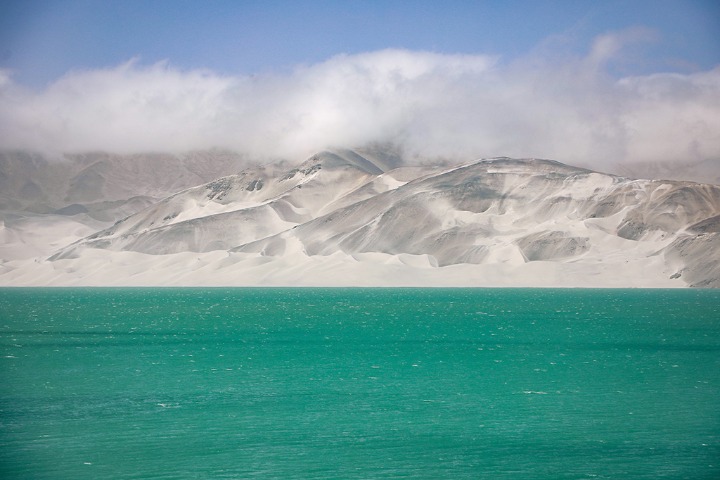 Mountain resembles silver dragon lying on rippling lake