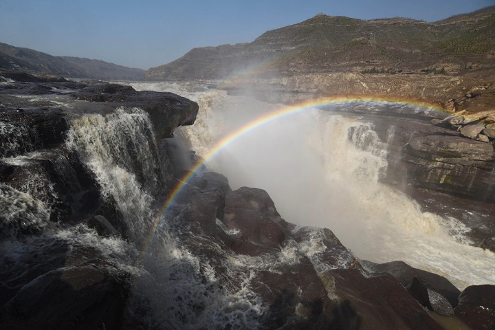 Rainbow appears over world’s largest yellow waterfall