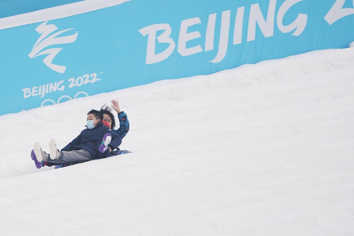 Tourists enjoy snow activities at Summer Palace in Beijing