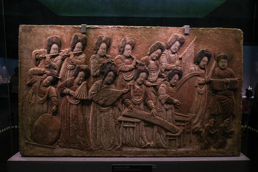 Painted relief carving portrays type of musical entertainment 1,000 years ago