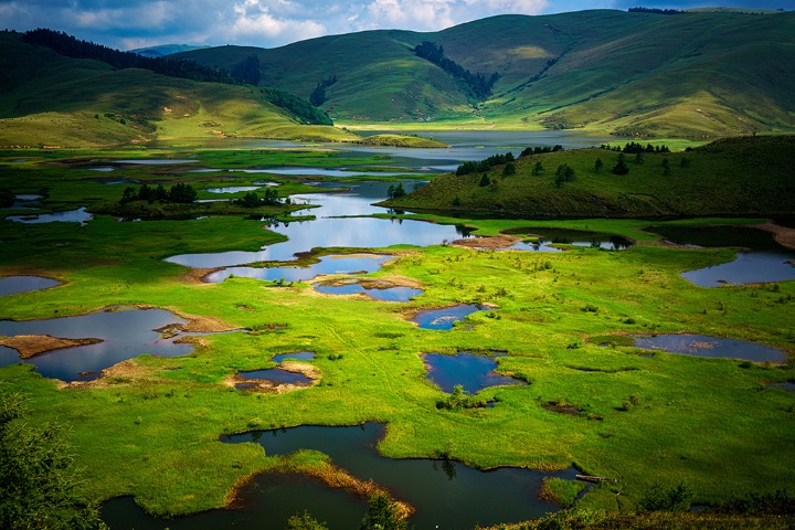 Meadows on Sichuan lake resemble land masses floating in the ocean