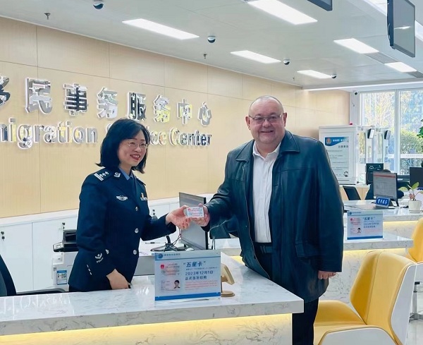 Expatriates receive new ID cards in Wuhan