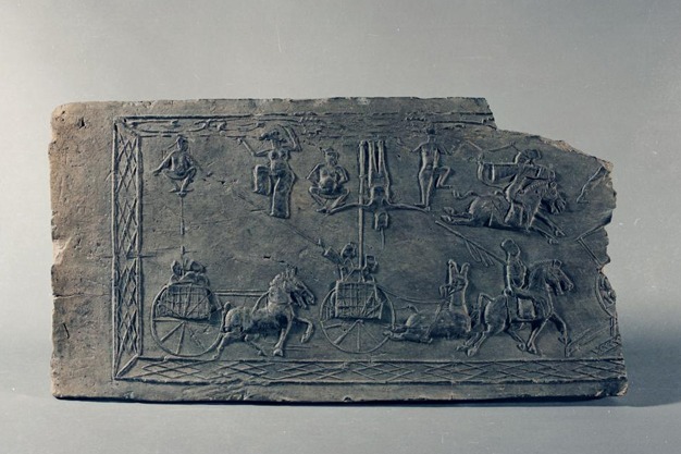 Brick relief captures ancient acrobatic show on moving chariots