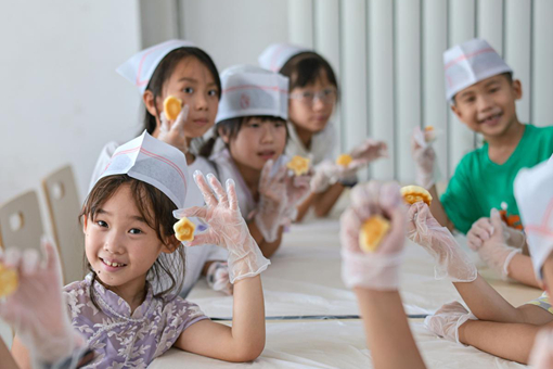 Children learn to make traditional pastry for love