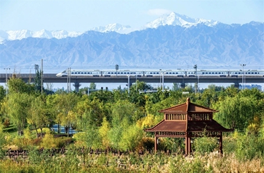 High-speed train through Zhangye in autumn, with Qilian Mountains as backdrop
