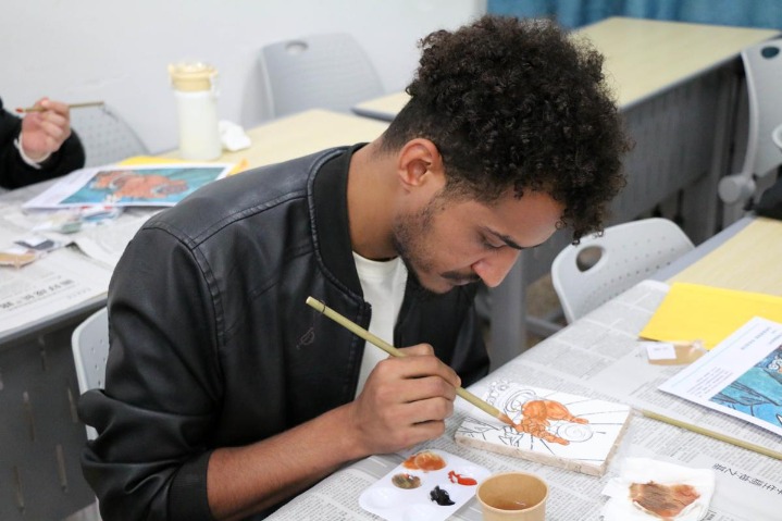 Students practice restoring Yuan Dynasty mural details at Shanxi University