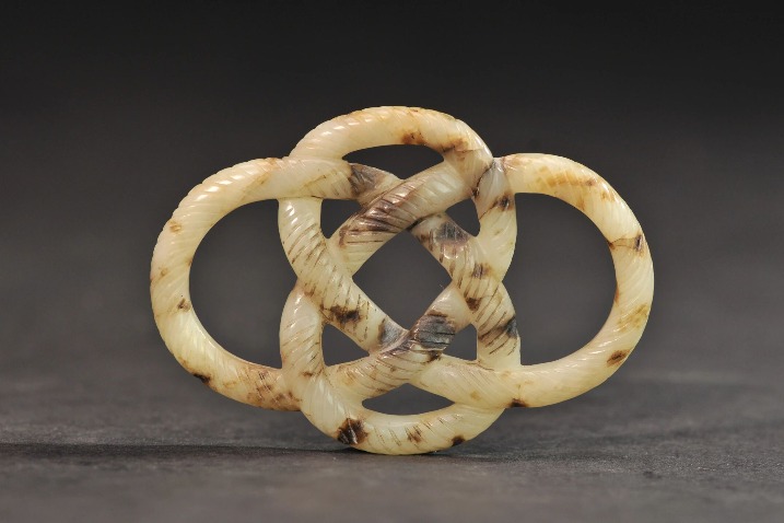 Ancient white jade pendant resembles twisted rope knot