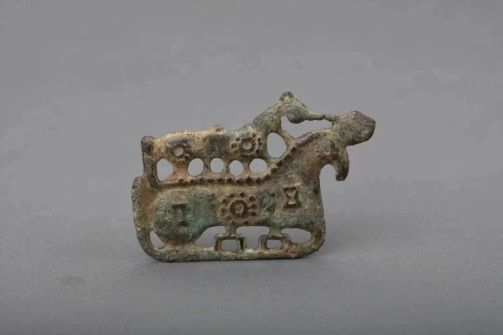 Bronze plaque ornament depicts two abstract horses