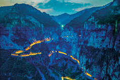 Remote villagers carve out a cliffside road to prosperity