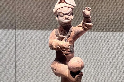 Ancient pottery figurine presents traditional cuju skills