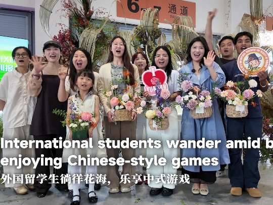 International students wander amid blooms, enjoying Chinese-style games